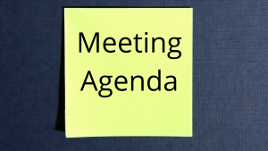 a bright yellow post-it not with Meeting Agenda written on it in black lettering