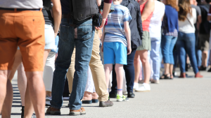 photograph of a long line of people queuing.