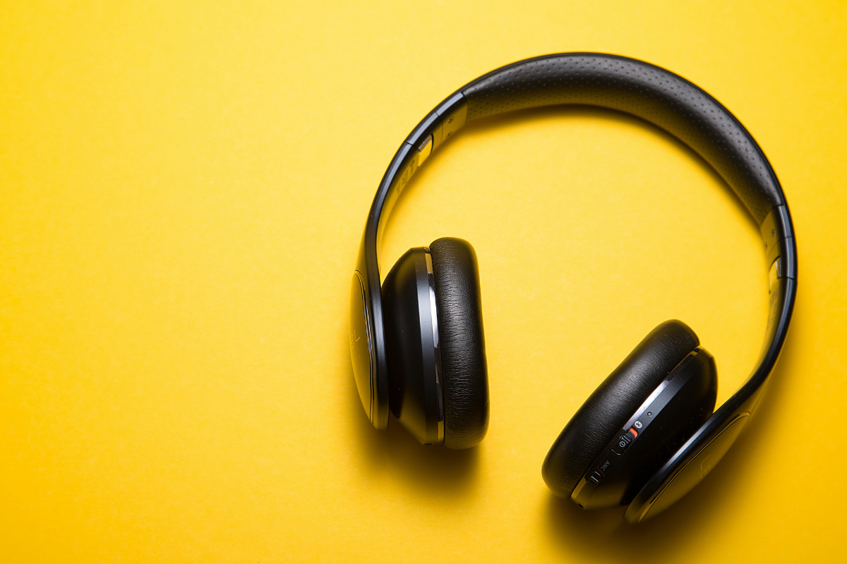 9 technology changes that can support D/deaf colleagues or those with hearing loss: A pair of headphones on a yellow background.
